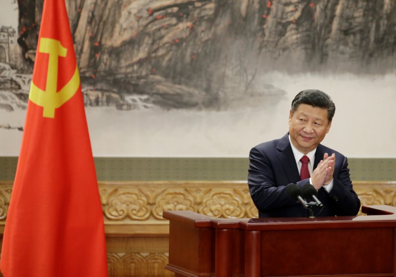 China's President Xi Jinping claps after his speech in Beijing