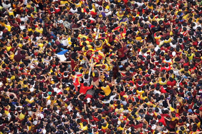 Devotees jostle as they try to reach an image of the Black Nazarene during the annual religious procession in Manila