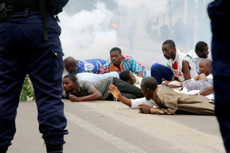 Riot policemen fire teargas canisters to disperse demonstrators during a protest organised by Catholic activists in Kinshasa