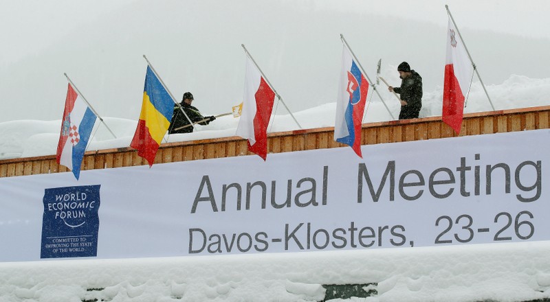Workers shovel snow from the roof of the congress centre in the Swiss mountain resort of Davos
