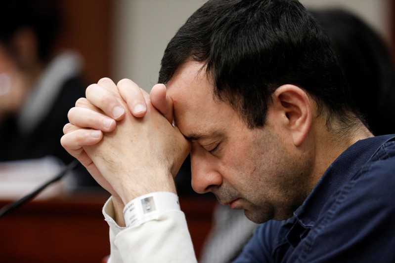Larry Nassar listens to a victim during his sentencing hearing in Lansing