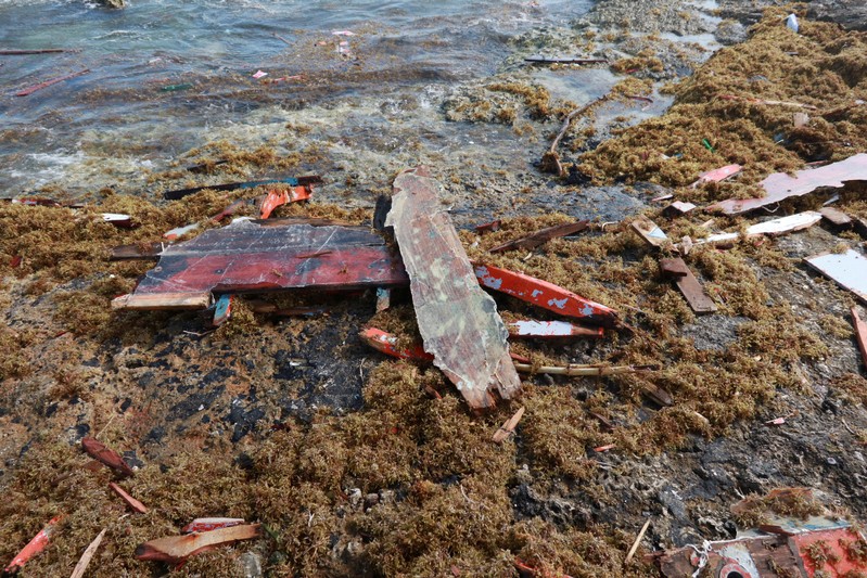 Pieces of wood are seen on the shore where bodies of four people were found, after their boat broke apart several miles before reaching Curacao, according to a Venezuelan family member of one of the passengers on board who survived, near Willemstad