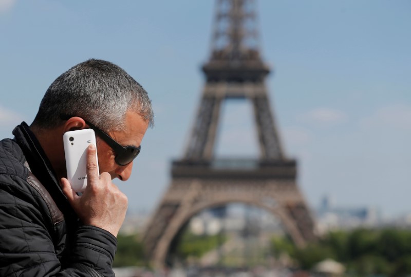 FILE PHOTO - A man makes a phone call using his mobile phone at the Trocadero Square near the Eiffel Tower in Paris