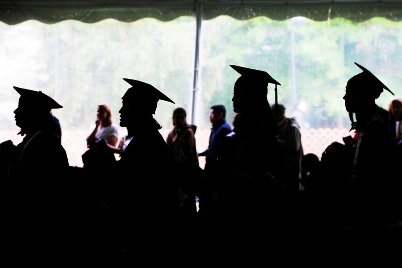 Graduating seniors line up to receive their diplomas during Commencement at Wellesley College in Wellesley