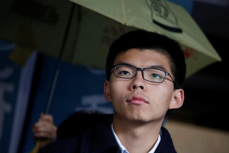 Former student leader Joshua Wong reacts outside High Court before receiving his sentence in Hong Kong