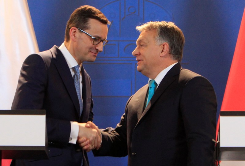 Polish PM Morawiecki and Hungarian PM Orban shake hands during a joint news conference in Budapest