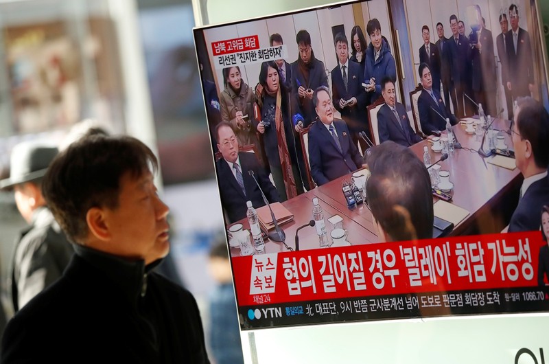 A man watches a TV broadcasting a news report on a high-level talks between the two Koreas at the truce village of Panmunjom, in Seoul