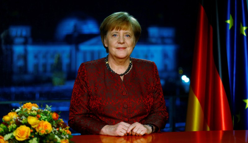 German acting Chancellor Merkel poses for photographs after the television recording of her annual New Year's speech at the Chancellery in Berlin