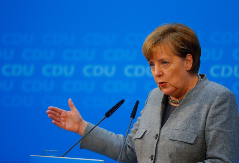 Acting German Chancellor Merkel address a news conference at the CDU party headquarters in Berlin