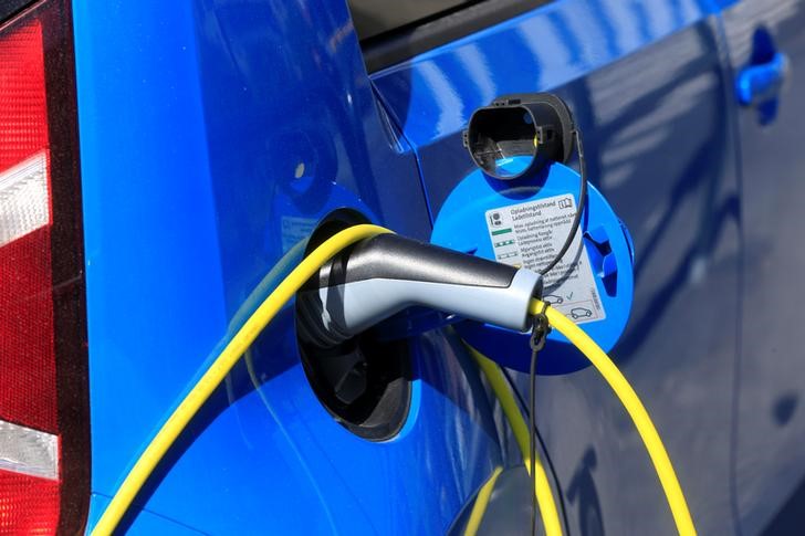 FILE PHOTO - An electric car is charged at a parking lot in Oslo