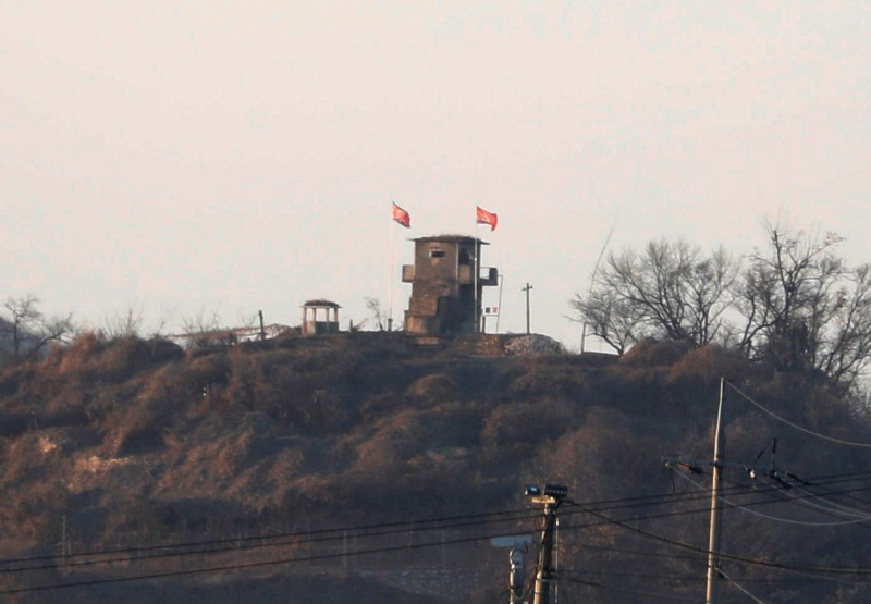 A North Korean flag flutters on the top of their guard post inside North Korean territory in this picture taken near the demilitarized zone separating the two Koreas in Paju