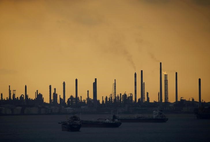 FILE PHOTO: Storm clouds gather over Shell's Pulau Bukom oil refinery in Singapore