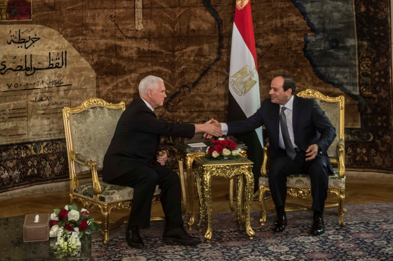 Egyptian President Abdel Fattah al-Sisi shakes hands with with U.S. Vice President Mike Pence during their meeting at the Presidential Palace in Cairo