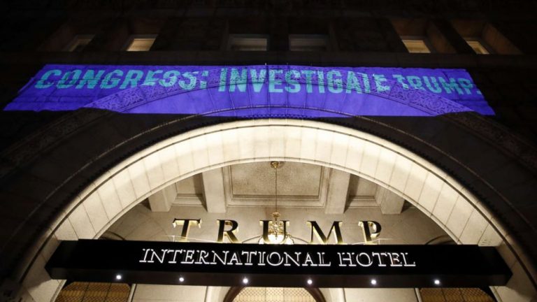 Protesters take to the streets, project anti-Trump messages onto his DC hotel