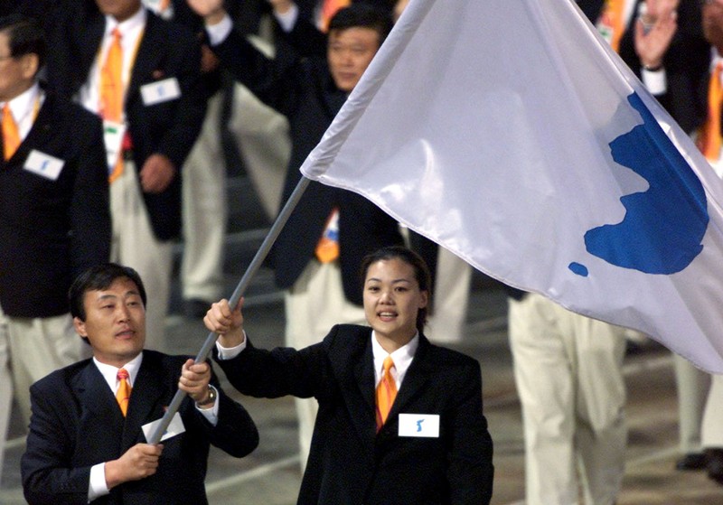 North Korea's Jang Choo Pak and South Korea's Eun-Soon Chung carry a flag bearing the unification symbol of the Korean peninsula during the opening ceremony of the Sydney 2000 Olympic Games, in Sydney