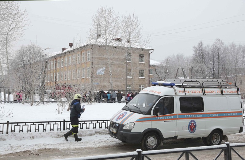 A vehicle of the Russian Emergencies Ministry is parked near a local school after reportedly several unidentified people wearing masks injured schoolchildren with knives in Perm