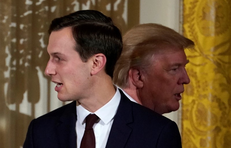 FILE PHOTO: U.S. President Donald Trump passes his adviser and son-in-law Jared Kushner during a Hanukkah Reception at the White House in Washington
