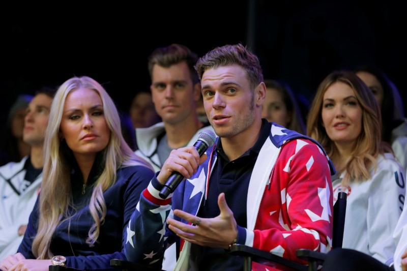 Olympian freestyle skier Gus Kenworthy speaks next to skier Lindsey Vonn during an event in Times Square to celebrate 100 days from the start of the PyeongChang 2018 Olympic Games in South Korea, in New York