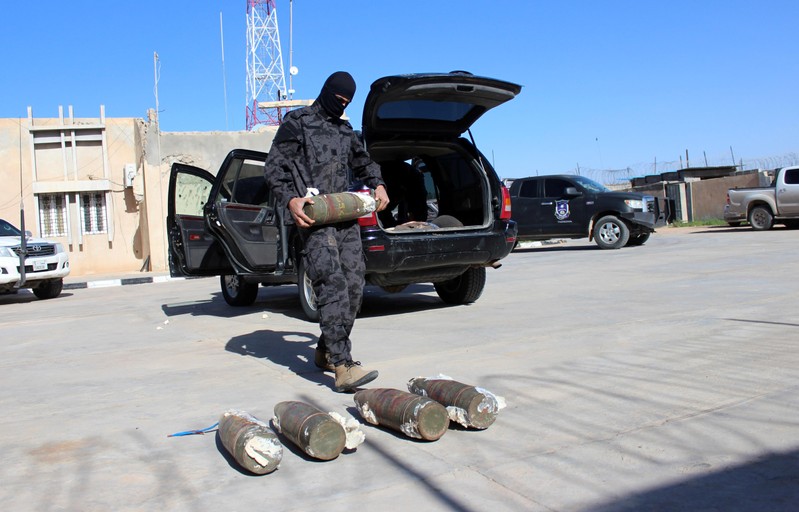 A security member of Misrata counter-terrorism removes explosives from a car driven by a suspected Islamic State militant, in Misrata