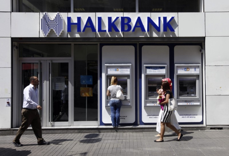 A customer uses an automated teller machine at a branch of Halkbank in Istanbul