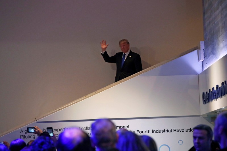FILE PHOTO: U.S. President Donald Trump walks down stairs after a round during the World Economic Forum (WEF) annual meeting in Davos