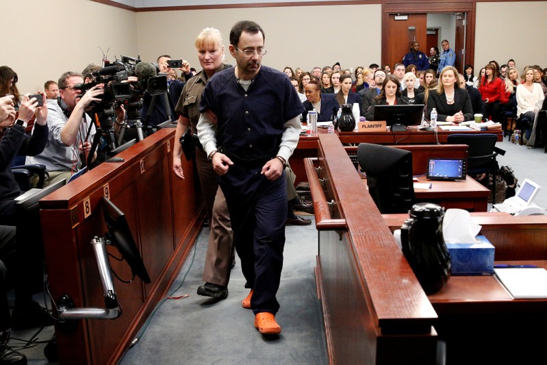 FILE PHOTO: Larry Nassar, a former team USA Gymnastics doctor who pleaded guilty in November 2017 to sexual assault charges, is escorted into the courtroom during his sentencing hearing in Lansing