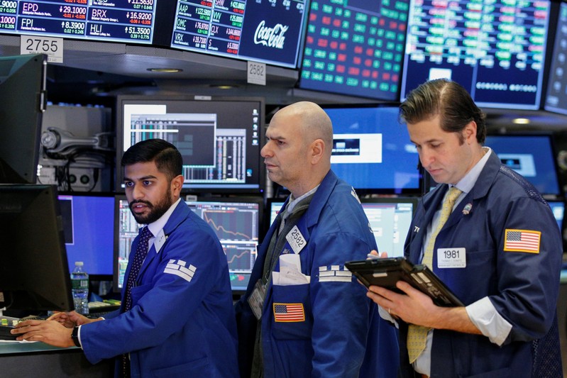 FILE PHOTO - Traders work on the floor of the NYSE in New York