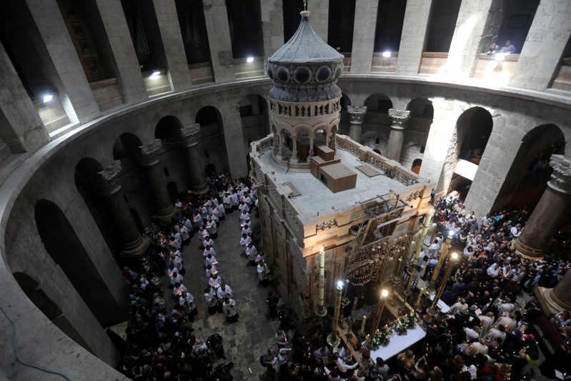 FILE PHOTO: Christian worshippers surround the Edicule as they take part in a Sunday Easter mass procession in the Church of the Holy Sepulchre in Jerusalem's Old City