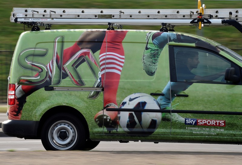 FILE PHOTO: A British Sky Broadcasting Group (BSkyB) work van is driven in west London