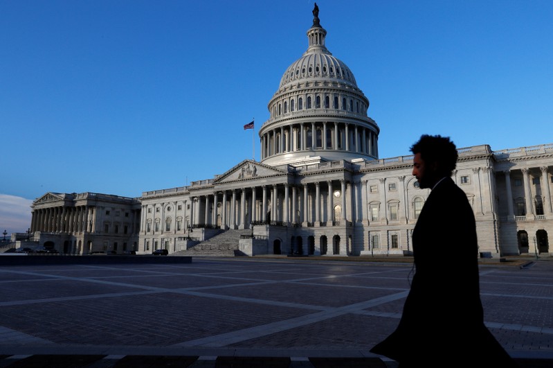People walk by the U.S. Capitol building in Washington