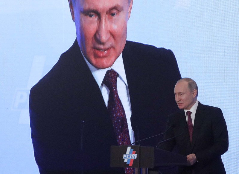 Russian President Putin attends a session during the Week of Russian Business in Moscow