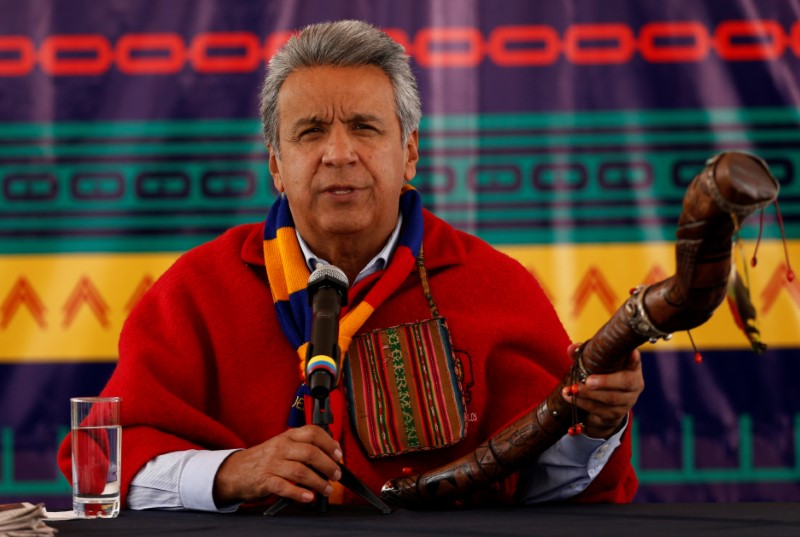 Ecuador's President Lenin Moreno holds a traditional Andean stick during a news conference in Cochasqui