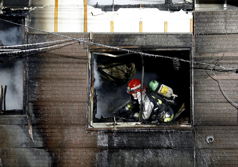 A firefighter inspects a facility to support senior people on welfare, where a fire occurred, in Sapporo