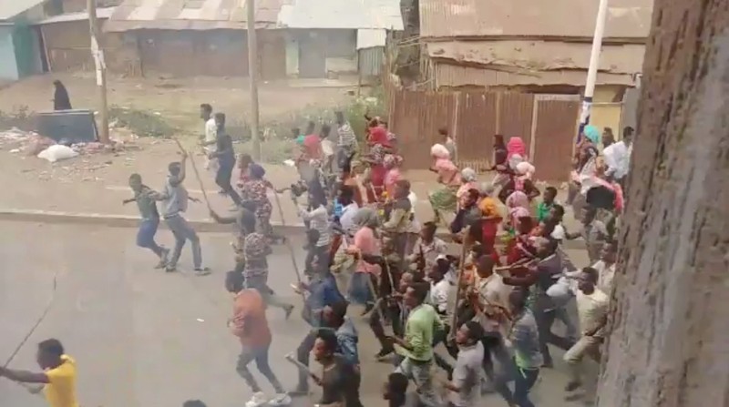 Demonstrators walk along a street in Asella, Oromiya Province