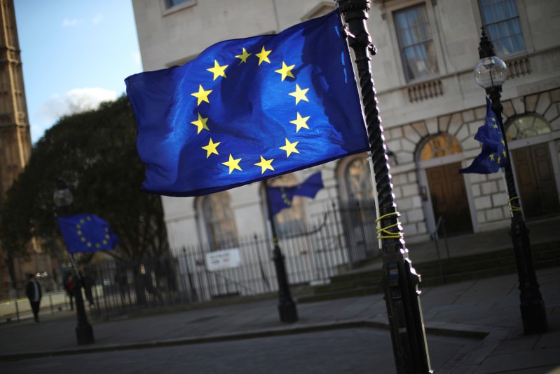 European Union flags fly from lamp posts opposite the Houses of Parliament in London