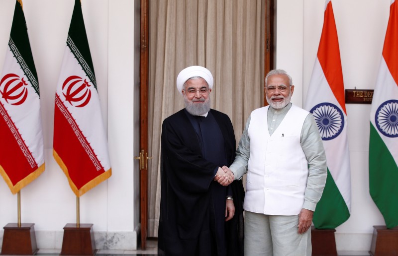 Iranian President Hassan Rouhani shakes hands with India's Prime Minister Narendra Modi (R) during a photo opportunity ahead of their meeting at Hyderabad House in New Delhi