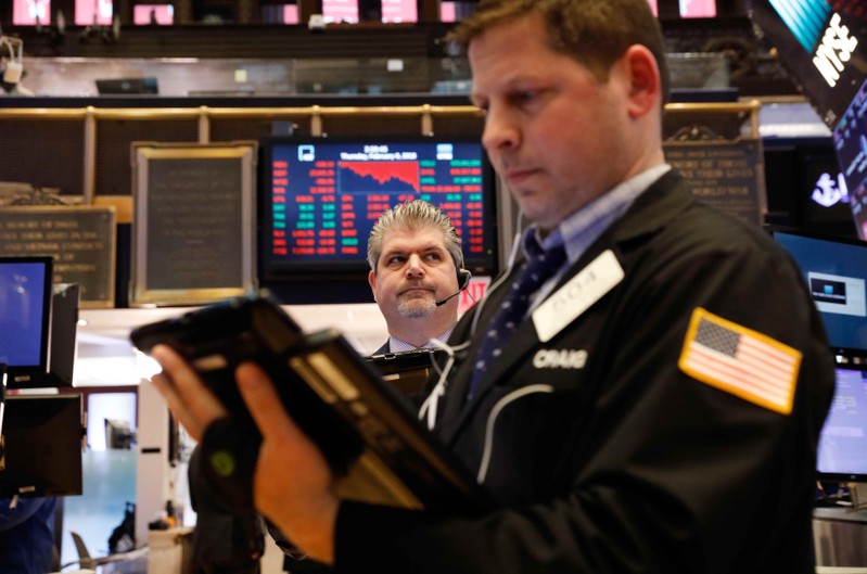 Traders work near the end of the day on the floor of the New York Stock Exchange in New York