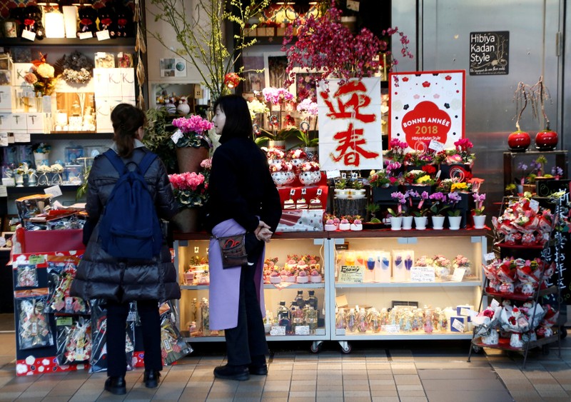 FILE PHOTO: A clerk talks to a customer at a flower shop at a shopping mall in Tokyo