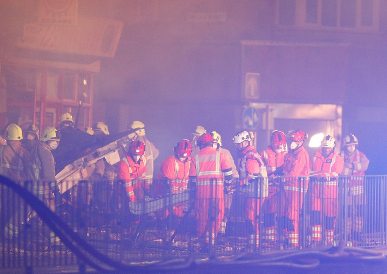 Members of the emergency services move debris at the site of an explosion which destroyed a convenience store and a home in Leicester