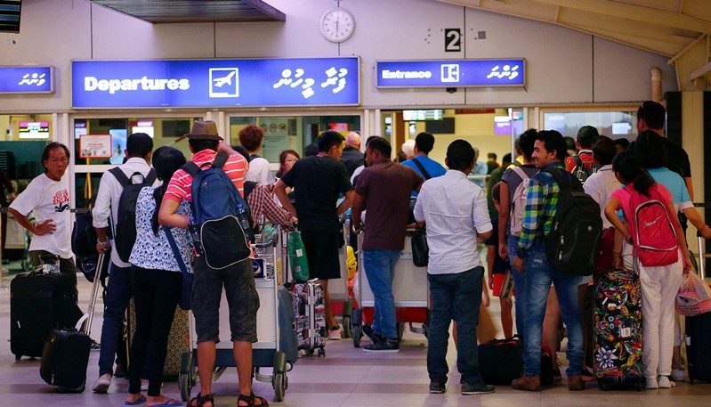 Tourists wait in the departures hall at Velana International Airport in Male