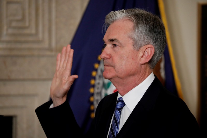 Federal Reserve Chairman Jerome Powell takes the oath of office administered by Federal Reserve Board member Randal Quarles at the Federal Reserve in Washington