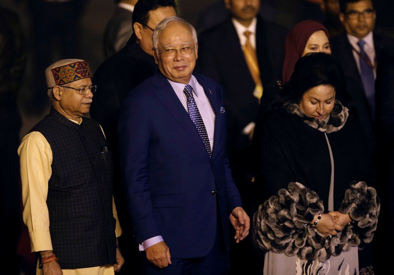 FILE PHOTO: Malaysia's Prime Minister Najib Razak and his wife Rosmah Mansor walk towards their car after arriving at Air Force Station Palam in New Delhi
