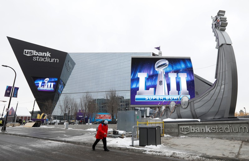 A man walks by US Bank Stadium, home to this weekend's Super Bowl, in downtown Minneapolis, Minnesota