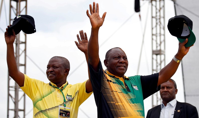 FILE PHOTO: President Cyril Ramaphosa and his ANC party deputy President David Mabuza wave to supporters ahead of the ANC's 106th anniversary celebrations in East Londo