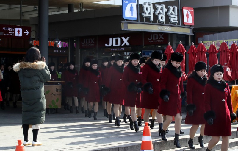 Members of North Korean cheering squad walk at an expressway service area in Gapyeong