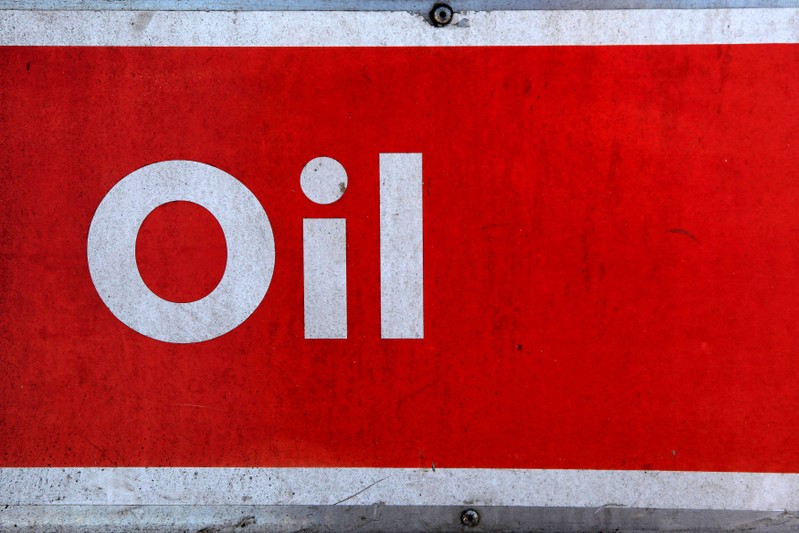 FILE PHOTO: The word oil is pictured on an oil bank at a recycling yard in London
