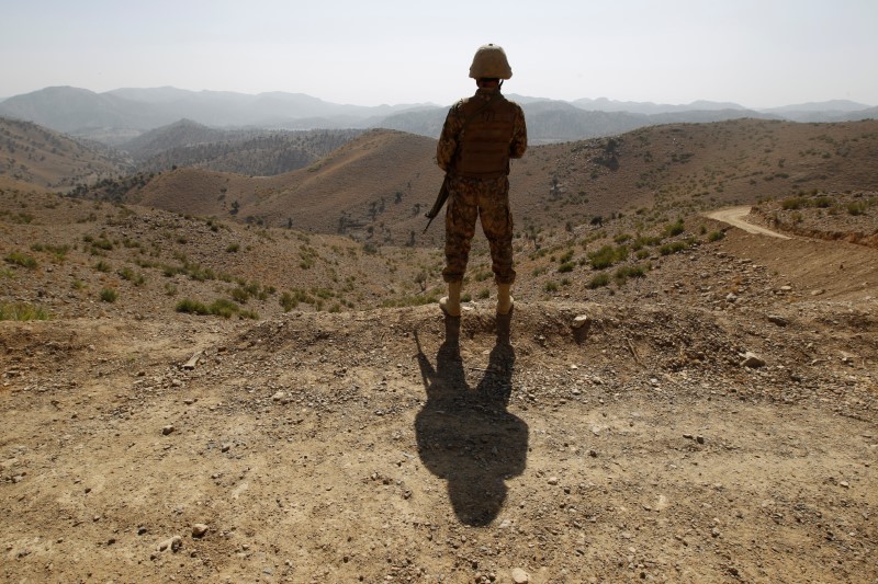 A soldier stands guard outside the Kitton outpost along the border fence on the border with Afghanistan in North Waziristan
