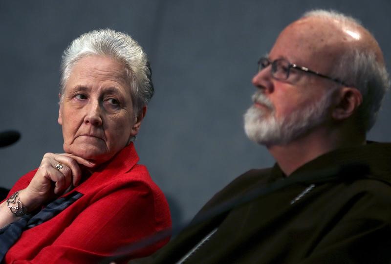 Collins, member of the Pontifical Commission for the Protection of Minors, looks at Cardinal O'Malley during their first briefing at the Holy See press office at the Vatican