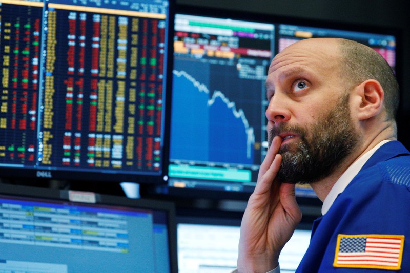 A trader reacts as he watches screens on the floor of the New York Stock Exchange in New York