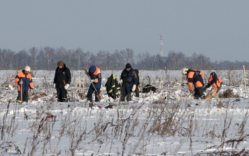 Russian Emergency Situations Ministry members work at the crash site of the short-haul AN-148 airplane operated by Saratov Airlines in Moscow Region